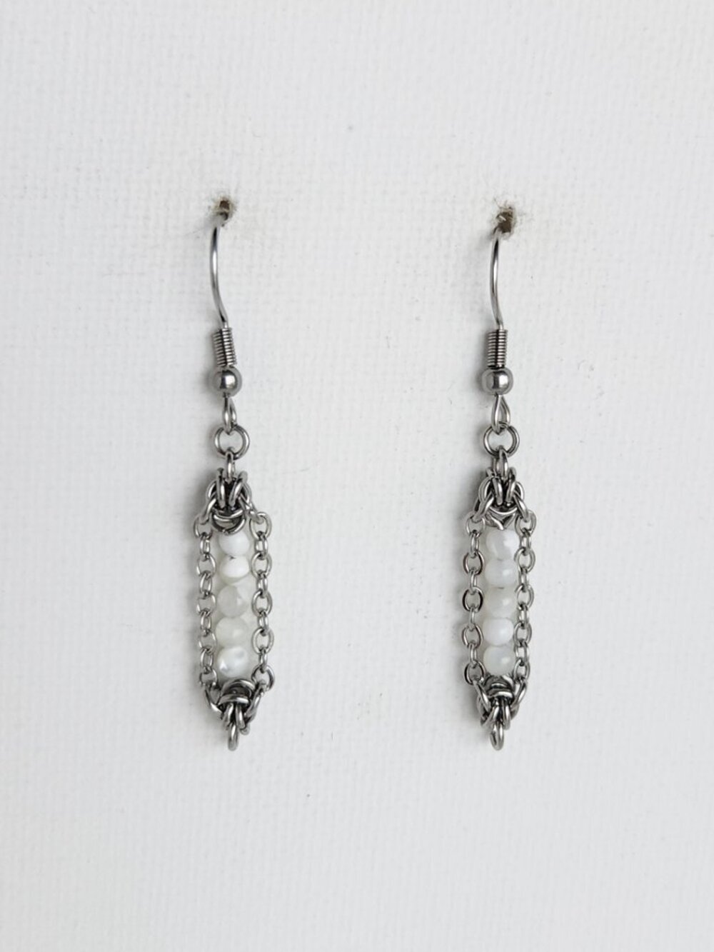 Small long silver earrings with white pearls